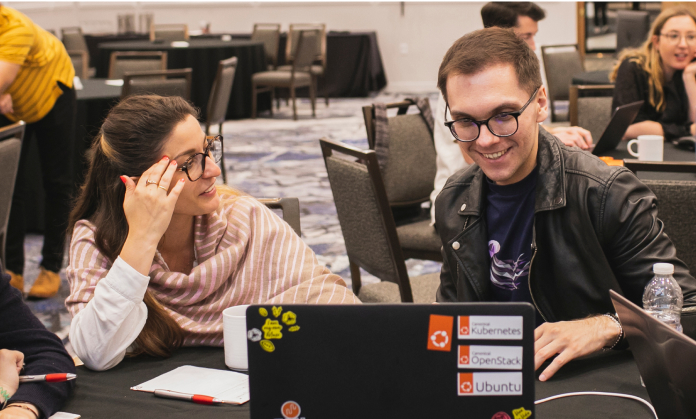 Employees working together on same laptop